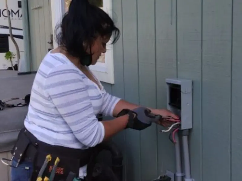 Licensed electrician wiring an exterior subpanel in Anoka